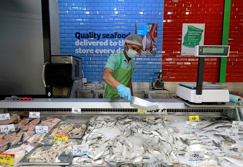 FILE PHOTO: A staff official wearing protective mask works at the meat and fish stall at a Keels super market, amid concerns about the spread of the coronavirus disease, in Colombo