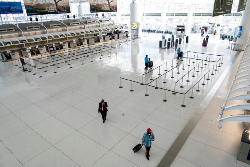 FILE PHOTO: People walk around the terminal at the John F. Kennedy International Airport in New York