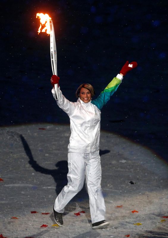 FILE PHOTO: Former Canadian speed skater Catriona Le May Doan carries the Olympic torches during the opening ceremony of the Vancouver Winter Olympic Games at the BC Place stadium in Vancouver