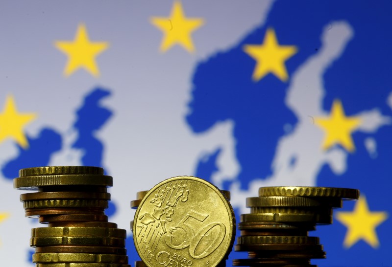 FILE PHOTO: Euro coins are seen in front of displayed flag and map of European Union in this picture illustration taken in Zenica