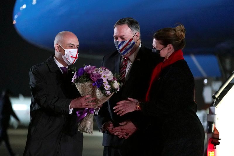 Georgian Foreign Minister David Zalkaliani gives flowers to Susan Pompeo as she and U.S. Secretary of State Mike Pompeo, arrive at Tbilisi International Airport