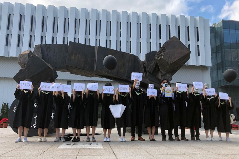 Students of Chinese University of Hong Kong (CUHK) hold up the names of the 12 detained in mainland China, in Hong Kong