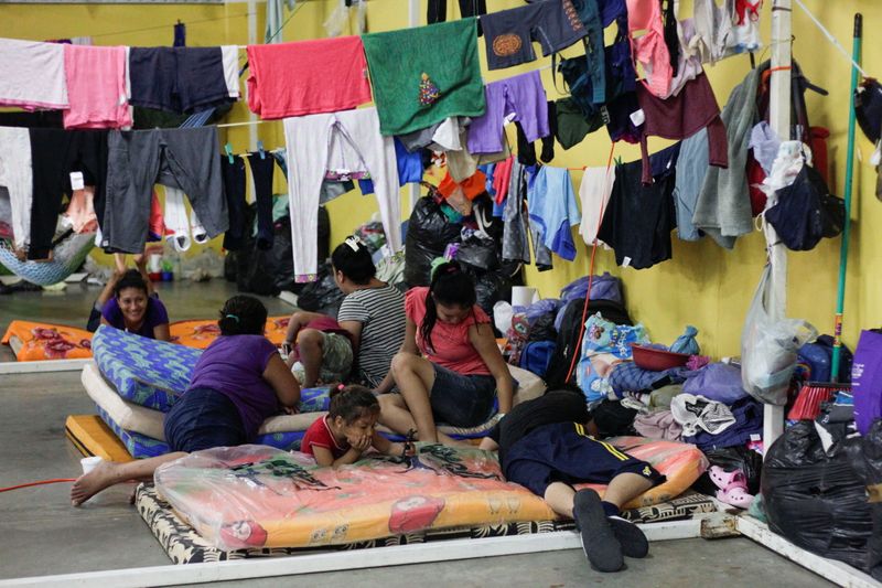 Residents rest at a shelter for people affected by the floods caused by heavy rain brought by Storm Iota, in San Pedro Sula