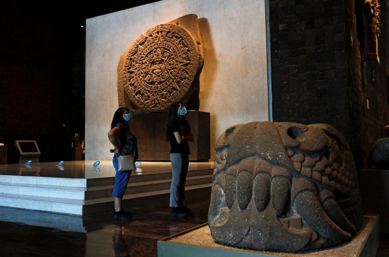 FILE PHOTO: People stand next to at the Aztec Sun Stone during a visit to the Mexico's National Museum of Anthropology, in Mexico City