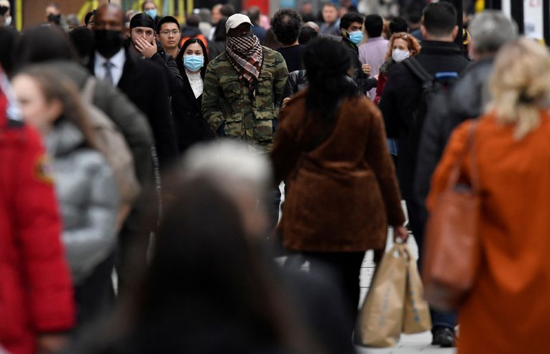 FILE PHOTO: Shoppers walk along Oxford Street, in the centre of London's retail shopping area, amid the spread of the coronavirus disease