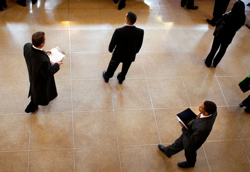 FILE PHOTO: Job seekers wait to meet potential employers at career fair at Rutgers University in New Brunswick