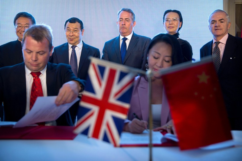 Image result for British Secretary of State for International Trade Liam Fox watches the signing ceremony for memorandums of understanding between British and Chinese firms and institutions at the British Ambassador's Residence in Beijing, China August 24, 2018.