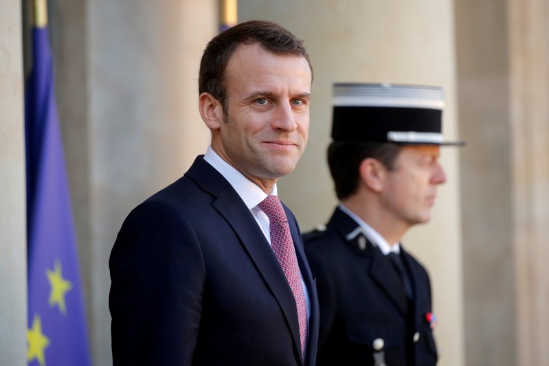 FILE PHOTO: French President Emmanuel Macron waits for the arrival of Tunisian Prime Minister Youssef Chahed at the Elysee Palace in Paris