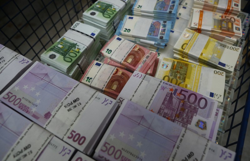 Wads of euro banknotes are stacked in a pile at the Money Service Austria company's headquarters in Vienna