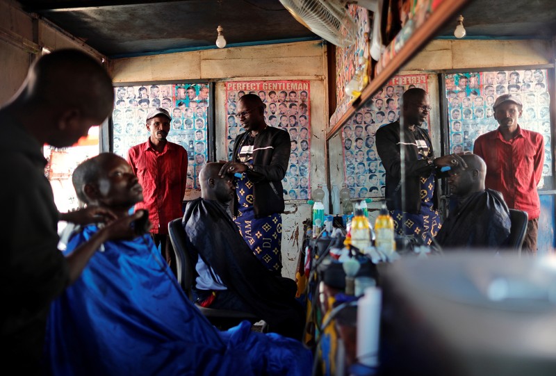 Yaya Niass, a hairdresser who works out of a road-side shack, is pictured inside his shop in Pikine, on the outskirts of Dakar
