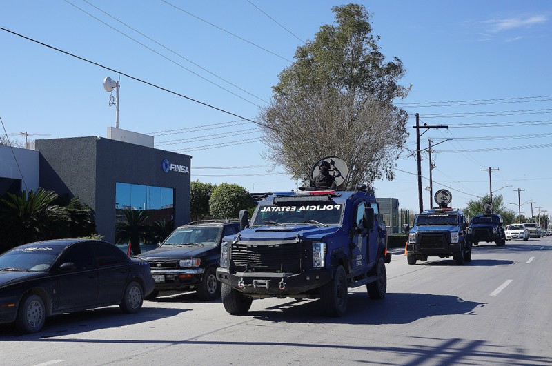 State police armoured vehicles patrol at an industrial park where employees from some plants are on strike in Matamoros
