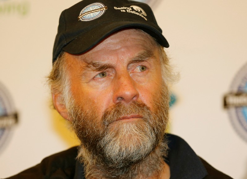 FILE PHOTO: British explorer Ranulph Fiennes listens during a news conference after his arrival at Heathrow Airport in London