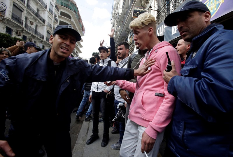Police try to disperse students who are protesting against President Abdelaziz Bouteflika's plan to extend his 20-year rule by seeking a fifth term in Algiers