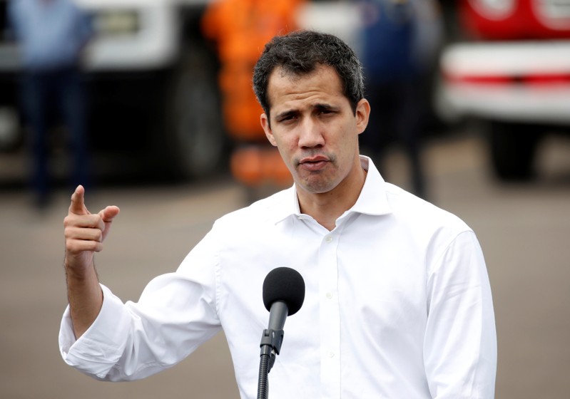 Venezuelan opposition leader Juan Guaido speaks to the media in the area of a warehouse where humanitarian aid for Venezuela has been collected in Cucuta