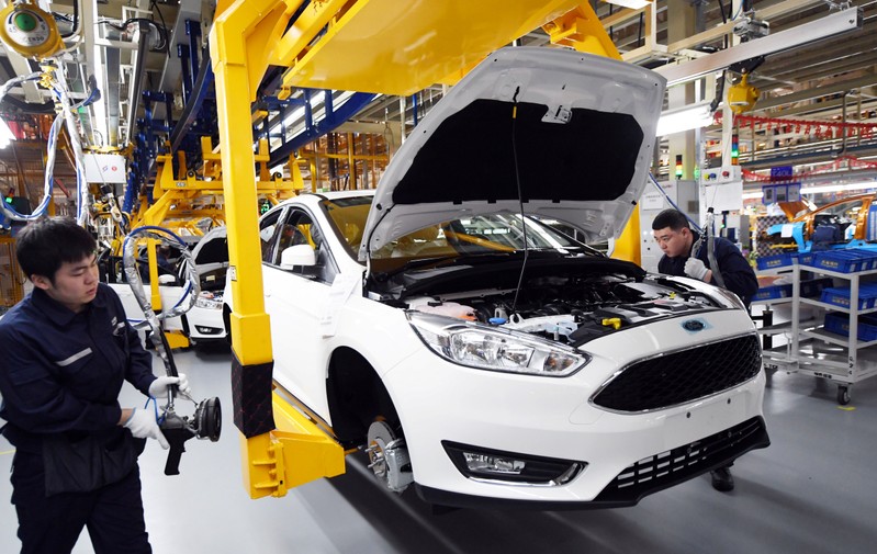 Workers assemble vehicles at a plant of Changan Ford in Harbin