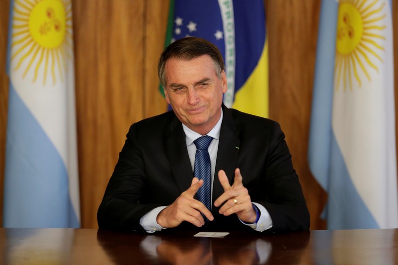 FILE PHOTO: Brazil's President Jair Bolsonaro gestures during a meeting with Argentina's President Mauricio Macri, at the Planalto Palace in Brasilia