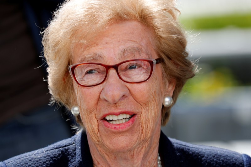 Auschwitz survivor Eva Schloss, stepsister of Holocaust diarist Anne Frank, listens to Chabad Rabbi Reuven Mintz at Newport Harbor High School after speaking with a group of students