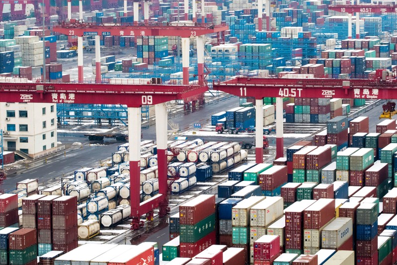 FILE PHOTO: Containers and trucks are seen following a snowfall at the port of Qingdao