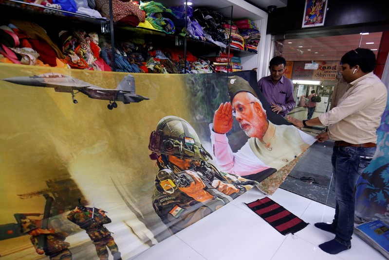 Traders display a sari with printed images of India's Prime Minister and Indian Army inside their shop in Surat