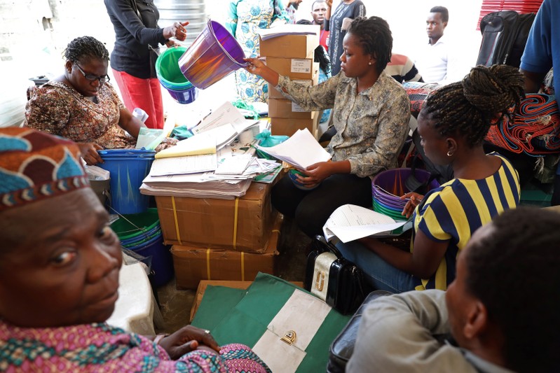 Independent National Electoral Commission (INEC) ad hoc workers sort election materials in Lagos