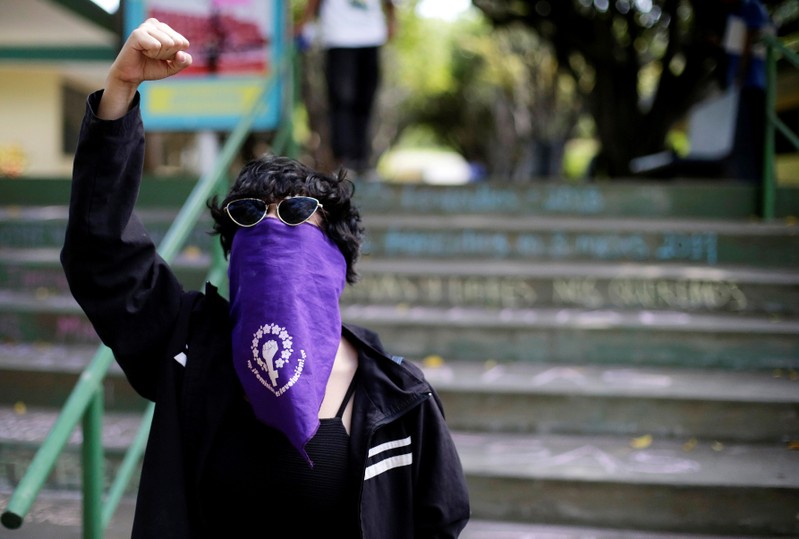FILE PHOTO: A masked demonstrator shouts slogans against Nicaraguan President Daniel Ortega's government during a protest to mark International Women's Day at UCA in Managua