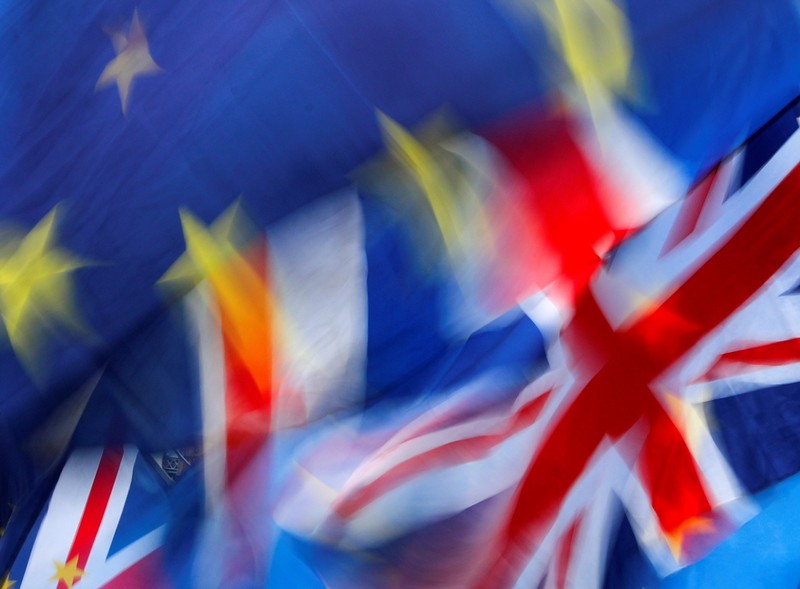 FILE PHOTO: British and EU flags flutter outside the Houses of Parliament during a pro-Brexit and anti-Brexit demonstration in London