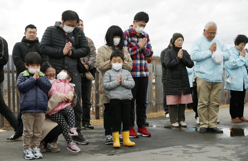 People pray to mourn victims at the time when the magnitude 9.0 earthquake struck off Japan's coast in 2011, in Iwaki, Fukushima prefecture