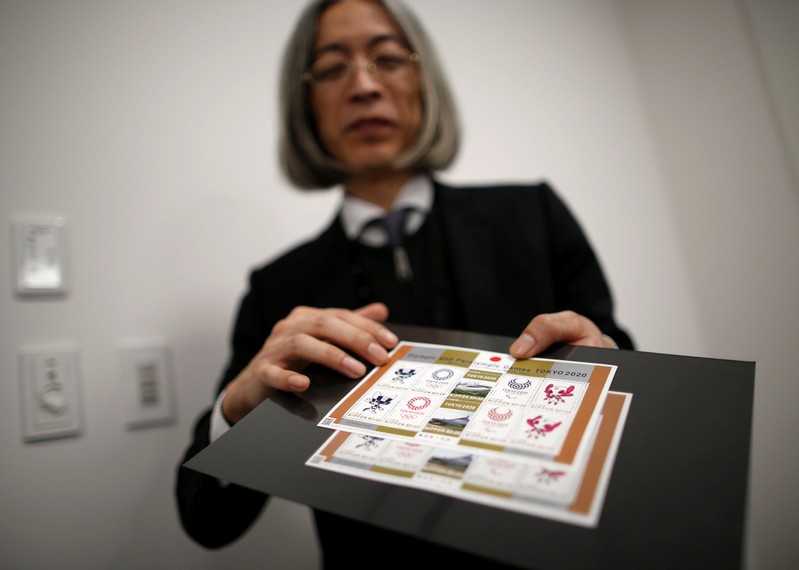 Japan Post Co. Ltd. chief stamp designer Akira Tamaki shows off the sheets of commemorative stamps for Tokyo 2020 Olympic and Paralympic Games in Tokyo