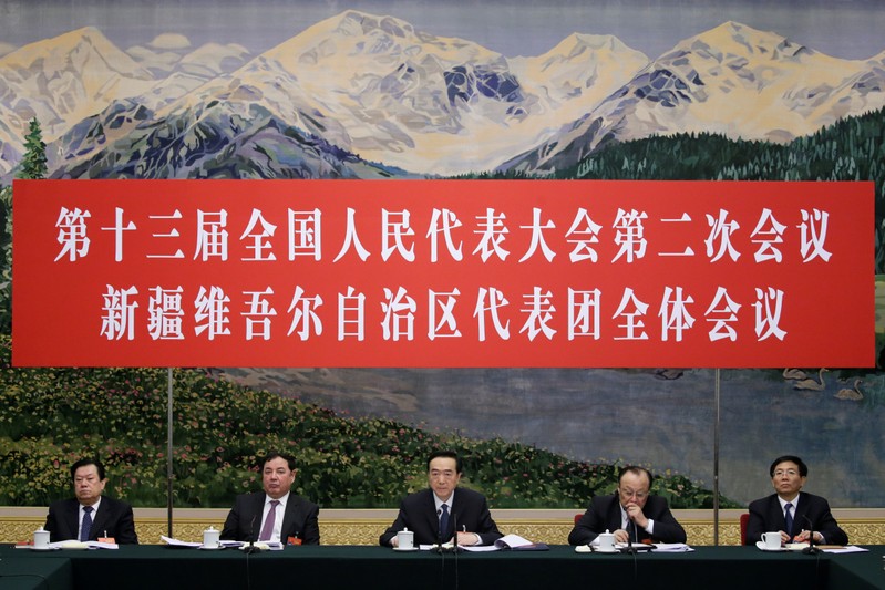 Officials attend the meeting of Xinjiang delegation on the sidelines of the National People's Congress (NPC), at the Great Hall of the People in Beijing