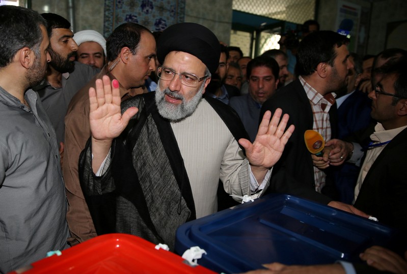 FILE PHOTO: Iranian presidential candidate Ebrahim Raisi gestures as he casts his vote during the presidential election in Tehran