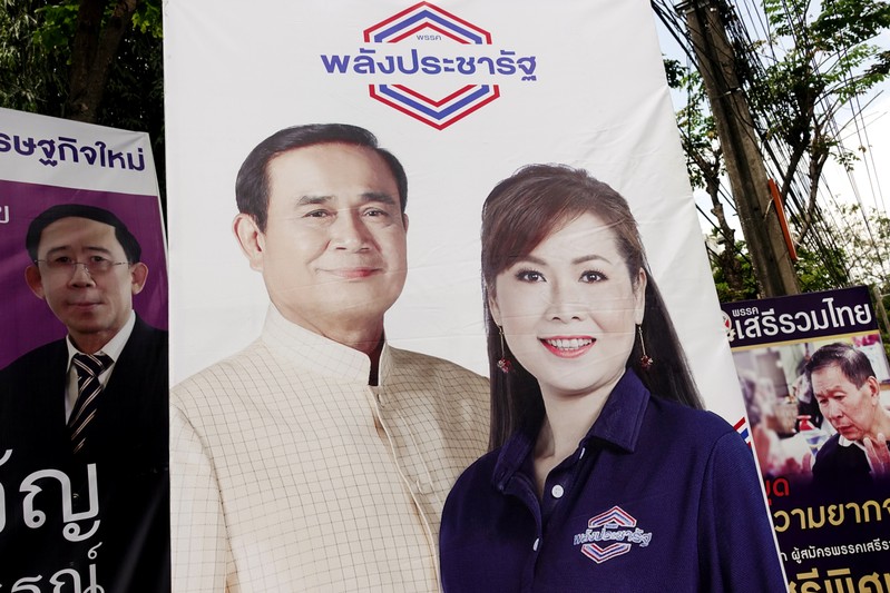 A picture of Thailand's Prime Minister Prayuth Chan-ocha is seen next to a candidate of Palang Pracharat party on an election campaign poster in Bangkok
