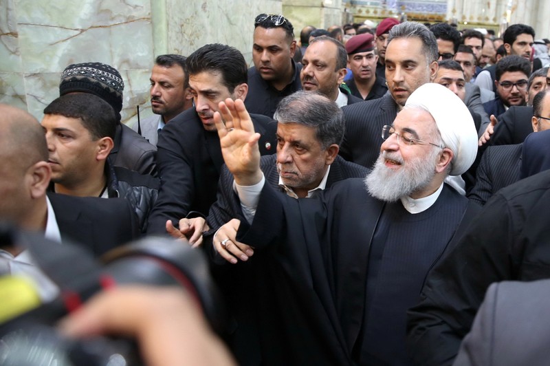 Iranian President Hassan Rouhani waves to the people at the Imam Ali shrine in Najaf