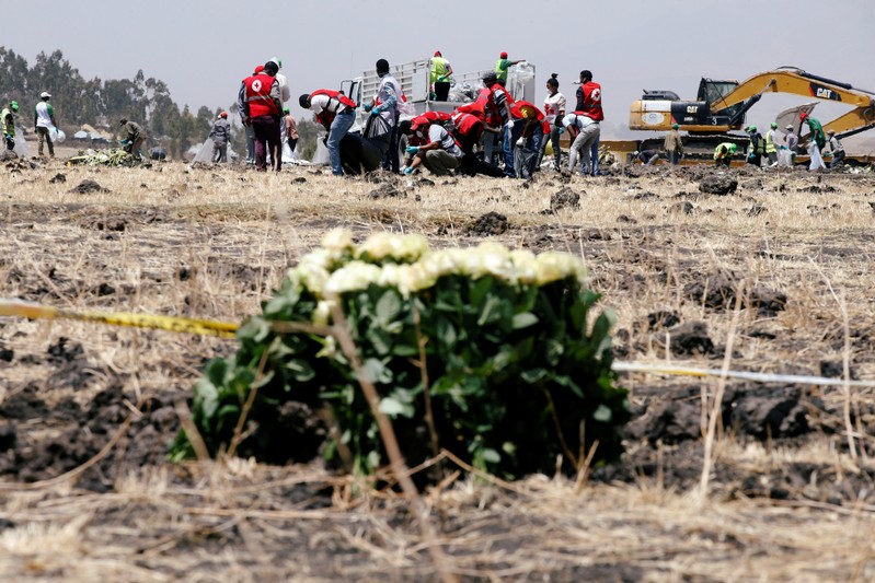 Members of the Ethiopian red cross search for remains at the Ethiopian Airlines Flight ET 302 plane crash before a commemoration ceremony at the scene of the crash, near the town of Bishoftu, southeast of Addis Ababa