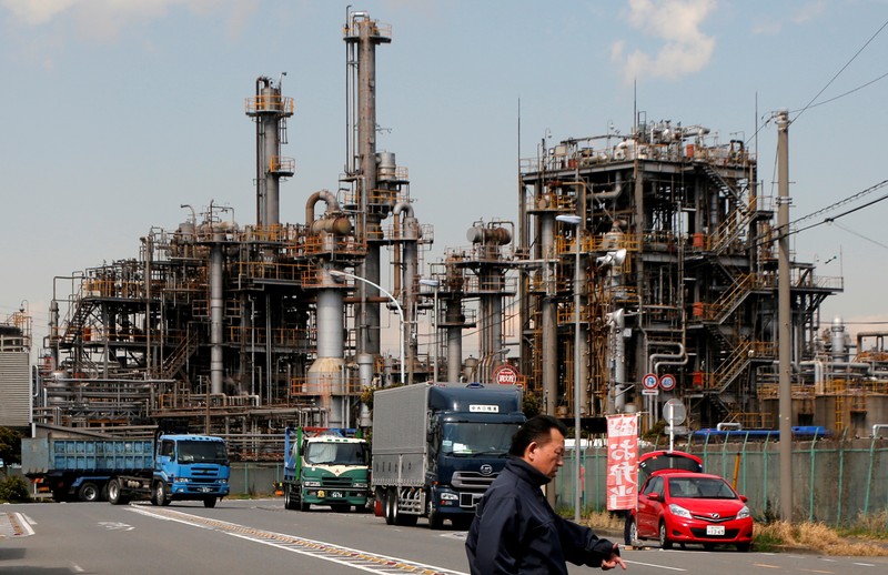 FILE PHOTO: Worker walks near a factory at the Keihin industrial zone in Kawasaki