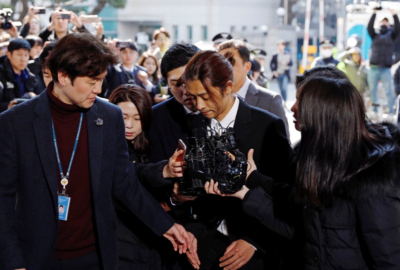 South Korean singer Jung Joon-young arrives for questioning on accusations of illicitly taping and sharing sex videos on social media, at the Seoul Metropolitan Police Agency in Seoul