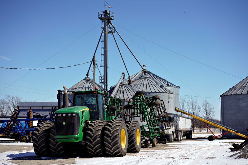 Farm equipment and grain storage belonging to farmer Austin Rincker sit outside in Moweaqua Illinois