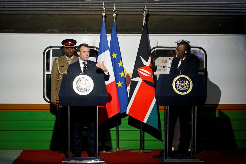 French President Emmanuel Macron flanked by Kenya's President Uhuru Kenyatta address a news conference after touring the Nairobi Central Railway in Nairobi,