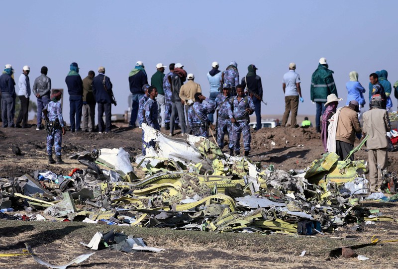 Ethiopian Federal policemen stand at the scene of the Ethiopian Airlines Flight ET 302 plane crash, near the town of Bishoftu