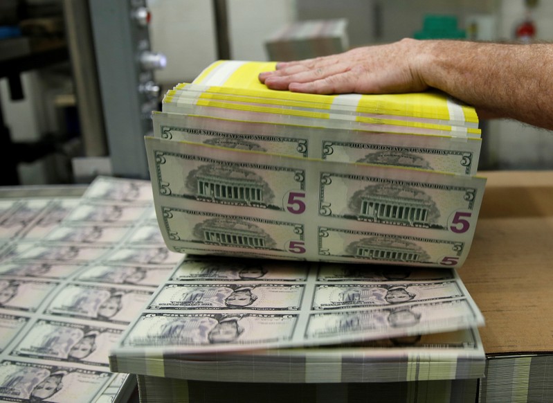 FILE PHOTO: Sheets of Lincoln five dollar bill are fanned out at the Bureau of Engraving and Printing in Washington