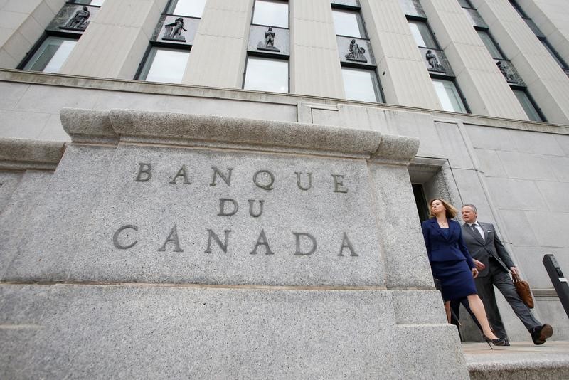 FILE PHOTO: Bank of Canada Governor Stephen Poloz and Senior Deputy Governor Carolyn Wilkins walk to a news conference in Ottawa