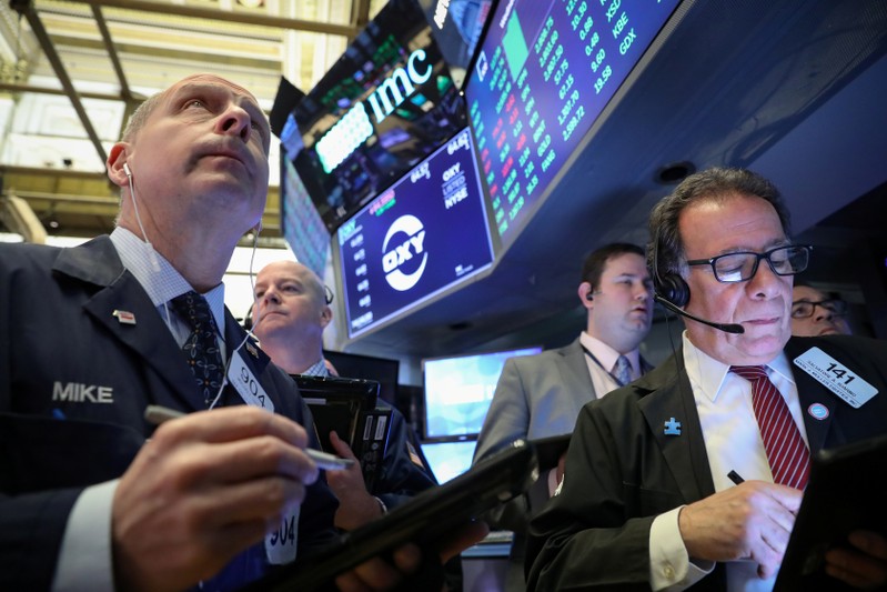 Traders work on the floor at the NYSE in New York