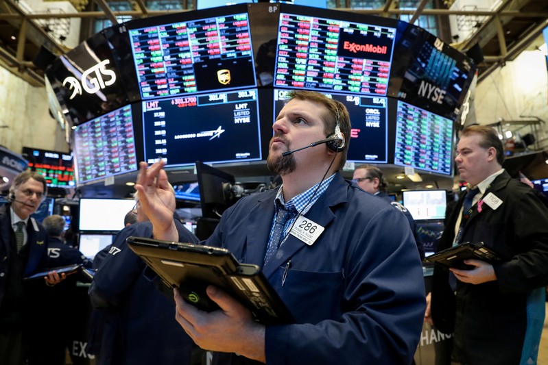 FILE PHOTO: Traders work on the floor of the NYSE in New York