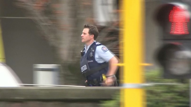 Video grab of a police officer running after reports that several shots had been fired at a mosque, in central Christchurch