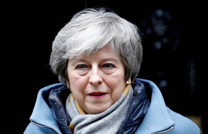 FILE PHOTO: British PM May walks outside Downing Street in London