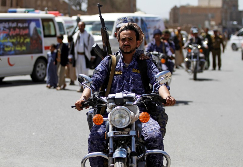 A Houthi security officer rides a motorbike during a funeral of people killed by an air strike last week in the northwestern province of Hajja, in Sanaa