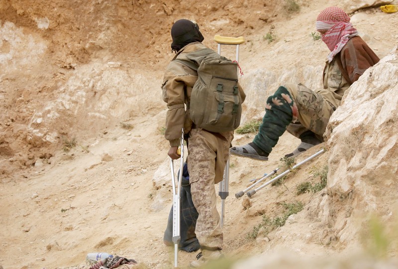FILE PHOTO: Injured Islamic state militants are seen in the village of Baghouz, Deir Al Zor province