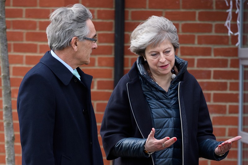 British Prime Minister Theresa May talks with Conservative MP for Wokingham John Redwood during a visit to a new housing development in Wokingham