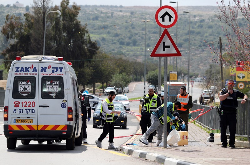 Israeli forensic police inspect the scene of Palestinian shooting attack near the Jewish settlement of Ariel, in the occupied West Bank