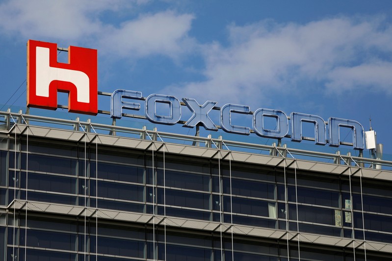 FILE PHOTO: The logo of Foxconn, the trading name of Hon Hai Precision Industry, is seen on top of the company's building in Taipei