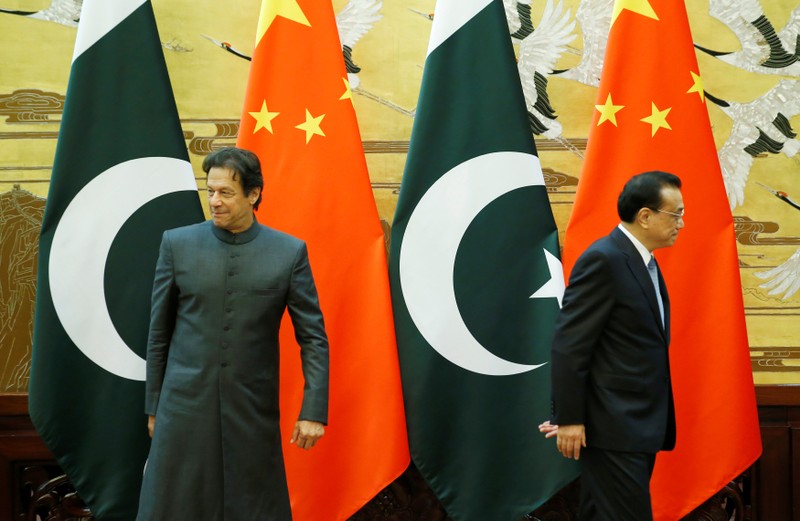 Pakistani Prime Minister Imran Khan and China's Premier Li Keqiang leave after a signing ceremony in Beijing